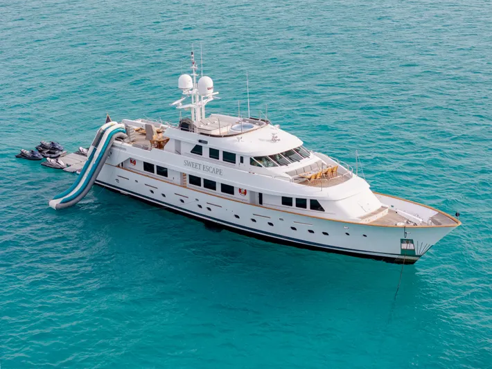 Sweet Escape Yacht Photos Pics Luxury 1993 Christensen Semi Displacement yacht with water slide in turquoise sea.