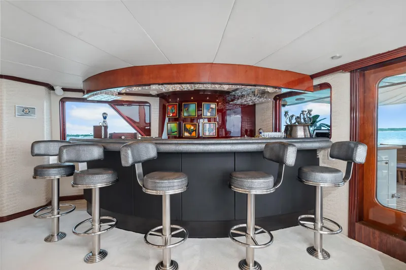 Sweet Escape Yacht Photos Pics Luxurious bar area on a 1993 Christensen Semi Displacement yacht with modern stools.