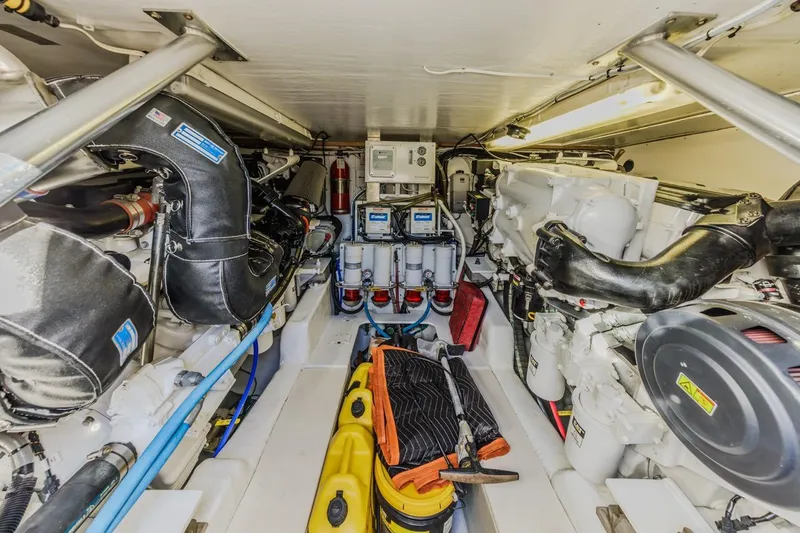 Kolohe Yacht Photos Pics Engine room of 1993 Ocean 65 Custom yacht, featuring mechanical equipment and tools.