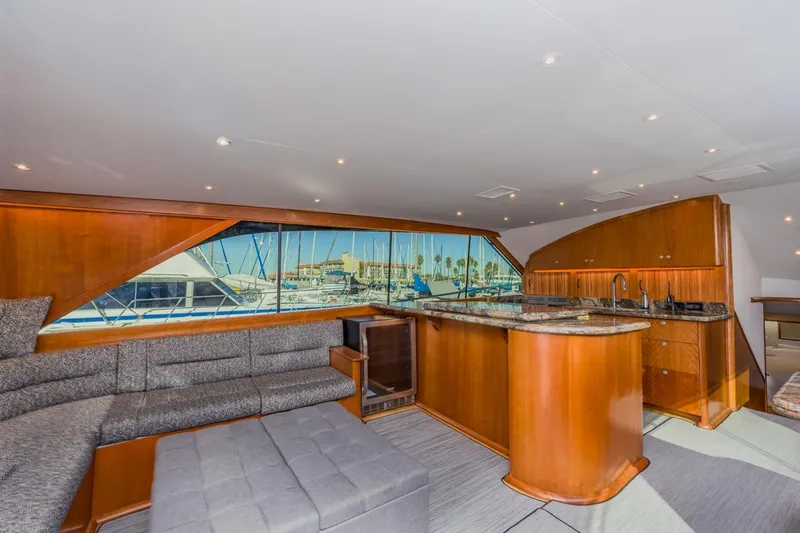 Kolohe Yacht Photos Pics Luxurious interior of 1993 Ocean 65 Custom yacht with elegant wood finishes and marina view.