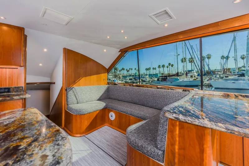 Kolohe Yacht Photos Pics Luxurious 1993 Ocean 65 Custom yacht interior with marina view through large windows.