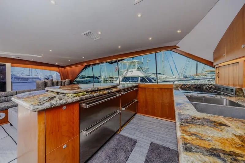 Kolohe Yacht Photos Pics Luxurious interior of 1993 Ocean 65 Custom yacht with granite countertops and marina view.