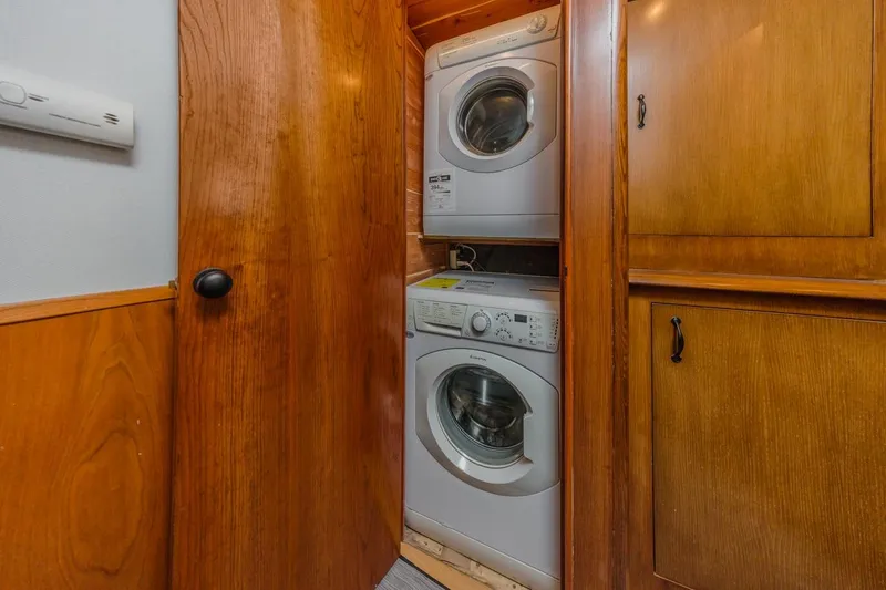 Kolohe Yacht Photos Pics Stacked washer and dryer in wooden cabinet on 1993 Ocean 65 Custom yacht.