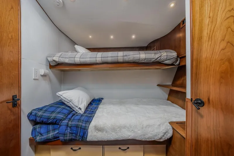 Kolohe Yacht Photos Pics Cozy bunk beds in 1993 Ocean 65 Custom yacht cabin with wooden accents.