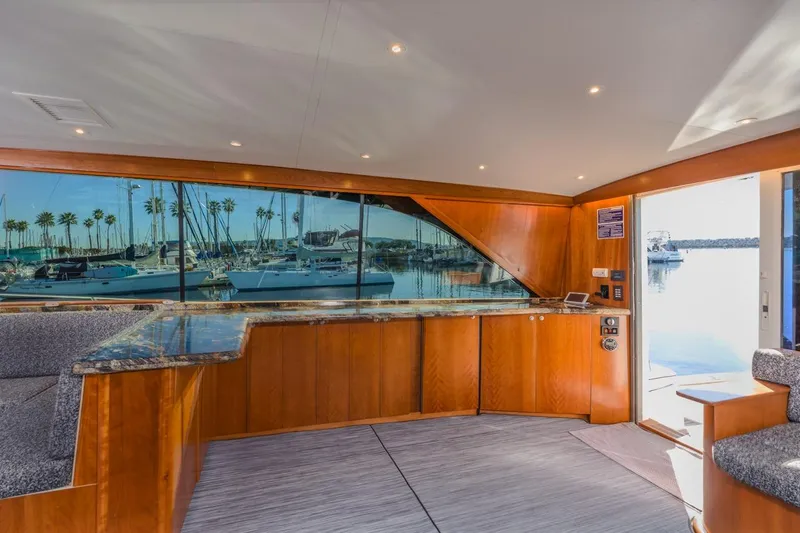 Kolohe Yacht Photos Pics Interior of 1993 Ocean 65 Custom yacht with marina view through large windows.