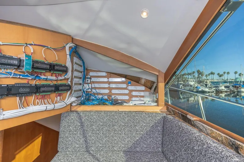 Kolohe Yacht Photos Pics Interior view of 1993 Ocean 65 Custom yacht with electrical panel and marina view.