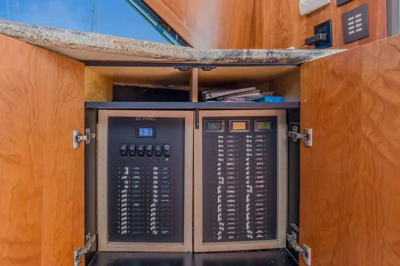 Kolohe Yacht Photos Pics Electrical panel inside 1993 Ocean 65 Custom yacht with wooden cabinetry.