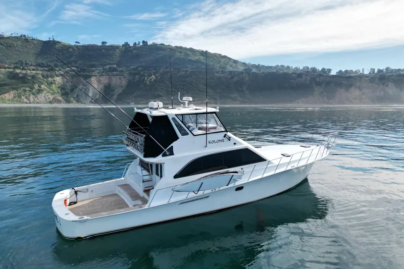 Kolohe Yacht Photos Pics 1993 Ocean 65 Custom yacht on calm waters with scenic coastal backdrop.