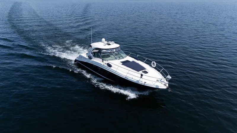  Yacht Photos Pics 2005 Sea Ray 420 Sundancer cruising on open water, aerial view.