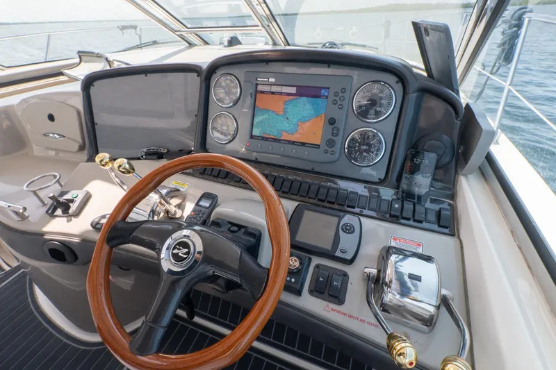  Yacht Photos Pics Helm of 2005 Sea Ray 420 Sundancer with navigation system and wooden steering wheel.