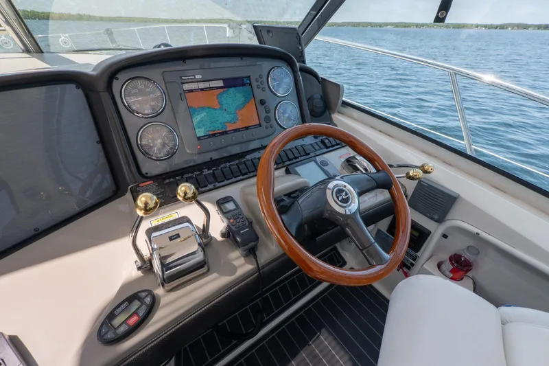  Yacht Photos Pics Helm of 2005 Sea Ray 420 Sundancer with navigation system and wooden steering wheel.