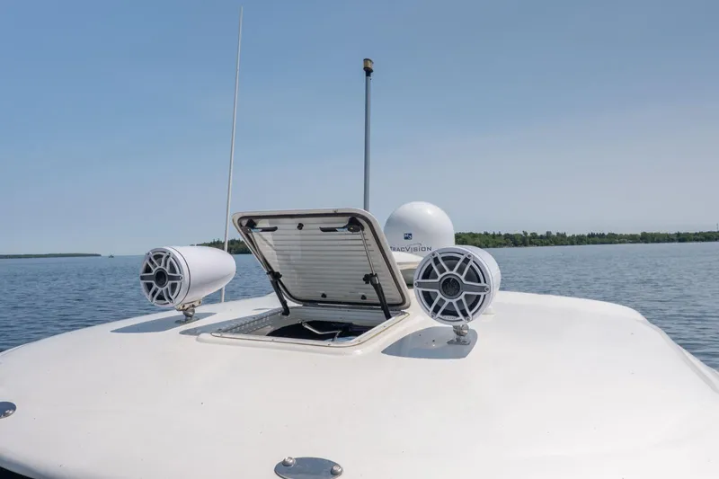  Yacht Photos Pics 2005 Sea Ray 420 Sundancer boat deck with open hatch and speakers on a calm lake.