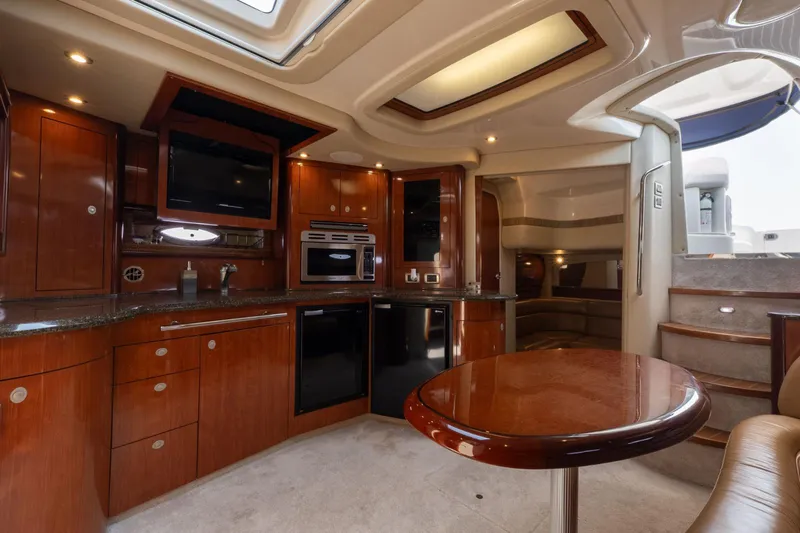 Yacht Photos Pics Luxurious interior of 2005 Sea Ray 420 Sundancer yacht with modern kitchen and seating area.