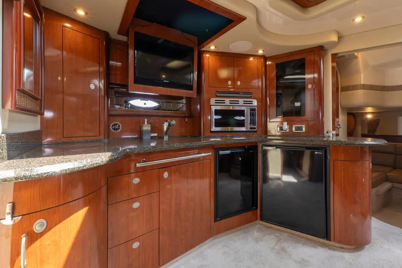  Yacht Photos Pics Luxurious 2005 Sea Ray 420 Sundancer yacht interior with modern kitchen and wood cabinetry.
