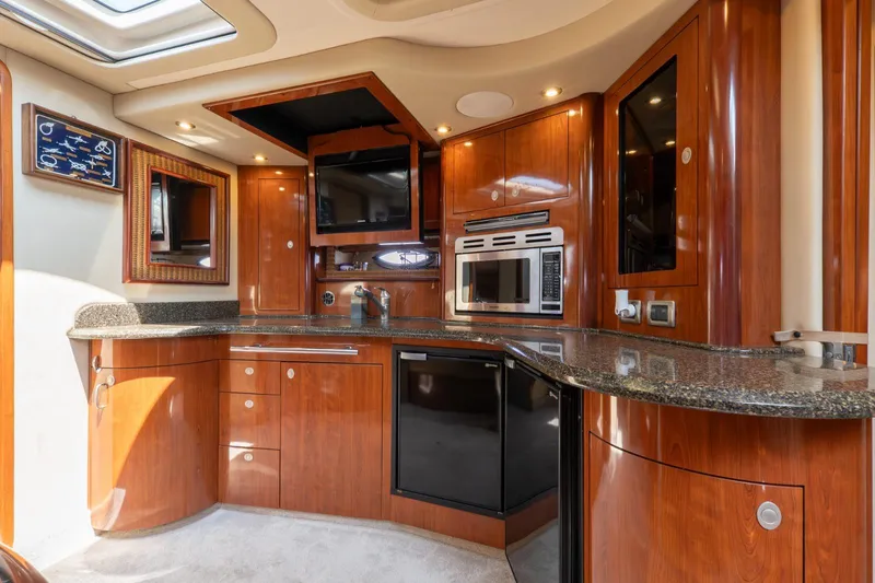  Yacht Photos Pics Luxurious 2005 Sea Ray 420 Sundancer yacht kitchen with wood cabinetry and modern appliances.