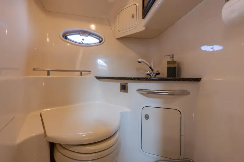  Yacht Photos Pics 2005 Sea Ray 420 Sundancer bathroom with sink, toilet, and porthole window.