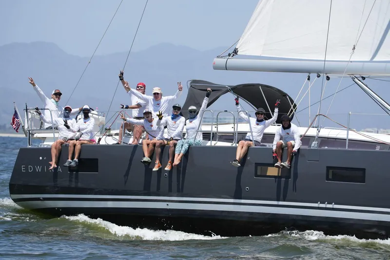 Edwina Yacht Photos Pics Crew sailing on a 2018 Jeanneau 54 yacht, enjoying a sunny day at sea.