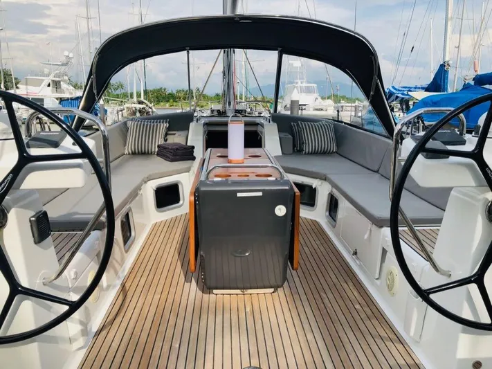 Edwina Yacht Photos Pics 2018 Jeanneau 54 yacht cockpit with dual steering wheels and cushioned seating.