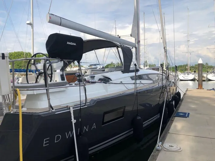Edwina Yacht Photos Pics 2018 Jeanneau 54 sailboat docked at marina, side view.