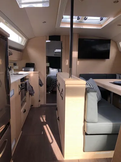 Edwina Yacht Photos Pics Interior of 2018 Jeanneau 54 yacht, featuring modern kitchen and cozy seating area.