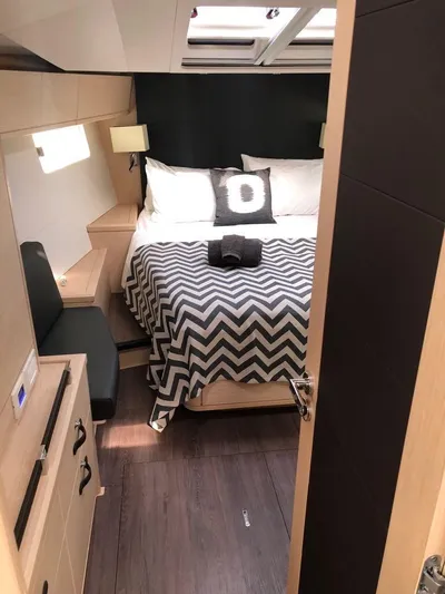 Edwina Yacht Photos Pics Luxurious cabin interior of 2018 Jeanneau 54 yacht with modern decor and cozy bedding.