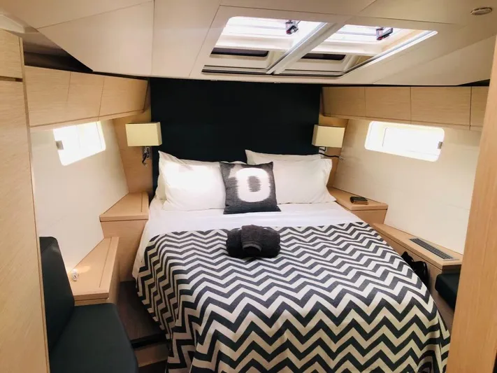 Edwina Yacht Photos Pics Luxurious cabin interior of 2018 Jeanneau 54 yacht with modern bedding and natural light.