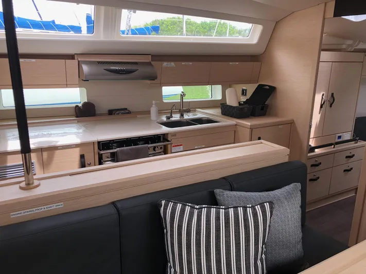Edwina Yacht Photos Pics Modern interior of 2018 Jeanneau 54 yacht with sleek kitchen and seating area.