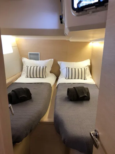 Edwina Yacht Photos Pics Cozy twin cabin in 2018 Jeanneau 54 yacht with modern decor and soft lighting.