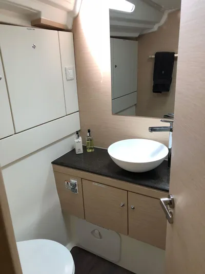 Edwina Yacht Photos Pics Modern bathroom in 2018 Jeanneau 54 yacht with sleek sink and cabinetry.