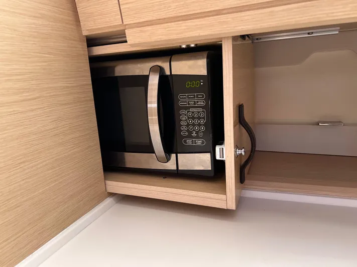 Edwina Yacht Photos Pics Microwave in 2018 Jeanneau 54 yacht's wooden cabinet kitchen area.