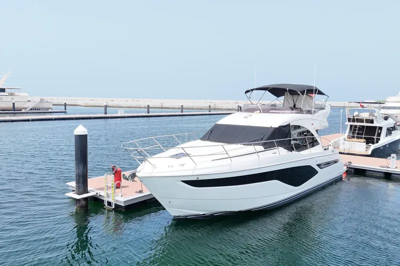  Yacht Photos Pics 2022 Princess F50 yacht docked at marina on a sunny day.