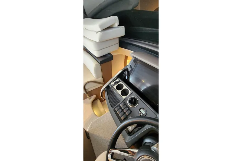  Yacht Photos Pics Interior view of 2022 Princess F50 yacht dashboard with modern controls and steering wheel.