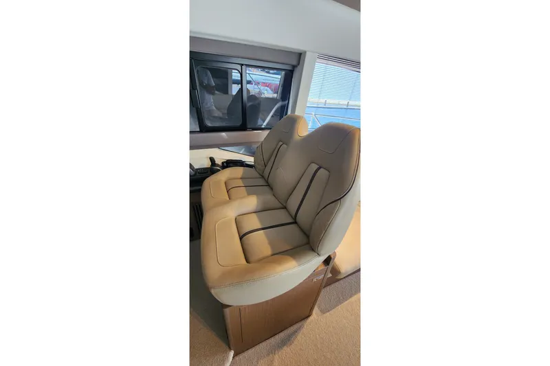  Yacht Photos Pics Luxurious beige seating inside 2022 Princess F50 yacht, showcasing modern design and comfort.