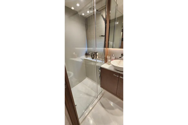  Yacht Photos Pics Luxurious bathroom in 2022 Princess F50 yacht with glass shower and modern fixtures.