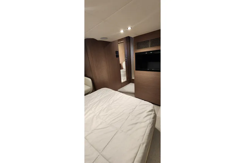  Yacht Photos Pics Luxurious interior of 2022 Princess F50 yacht bedroom with modern design and cozy ambiance.