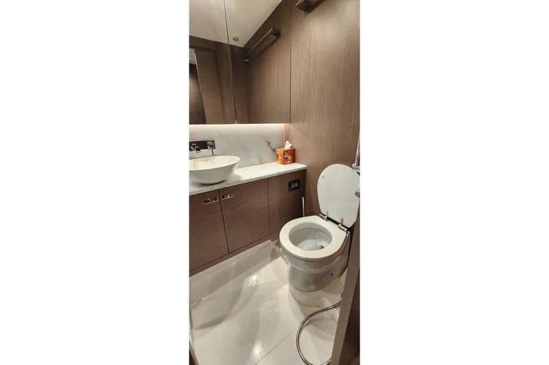  Yacht Photos Pics Luxurious bathroom in 2022 Princess F50 yacht with modern fixtures and elegant design.
