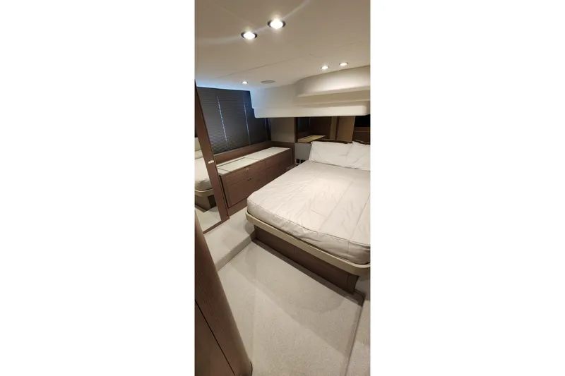  Yacht Photos Pics Luxurious bedroom interior of 2022 Princess F50 yacht with modern design and cozy ambiance.