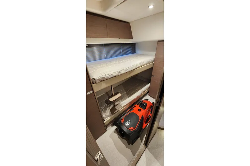  Yacht Photos Pics 2022 Princess F50 yacht interior with bunk beds and orange water scooter.