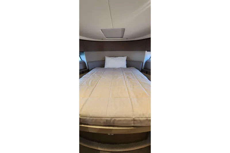  Yacht Photos Pics Luxurious cabin interior of 2022 Princess F50 yacht with cozy bed and modern design.