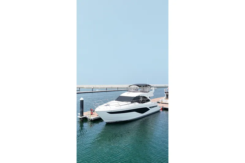  Yacht Photos Pics Luxury 2022 Princess F50 yacht docked at marina under clear blue sky.