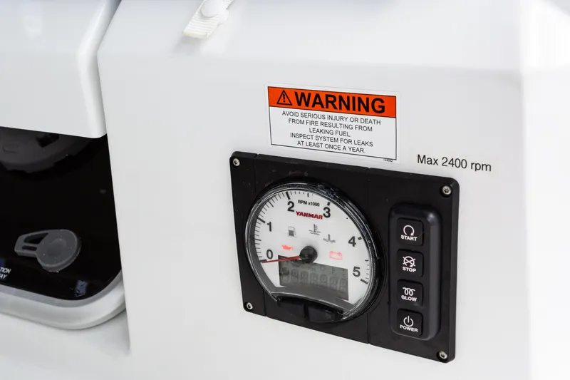 Off The Clock Yacht Photos Pics Control panel of a 2020 Jeanneau Sun Odyssey 349 sailboat with warning label.