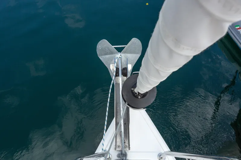 Off The Clock Yacht Photos Pics Bow view of 2020 Jeanneau Sun Odyssey 349 sailboat with anchor and furled sail.