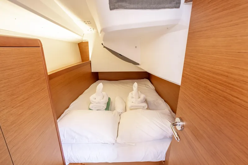 Off The Clock Yacht Photos Pics Cozy cabin interior of 2020 Jeanneau Sun Odyssey 349 with neatly arranged towels.