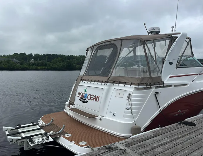  Yacht Photos Pics 2006 Rinker 390 Express Cruiser docked by a wooden pier on a cloudy day.