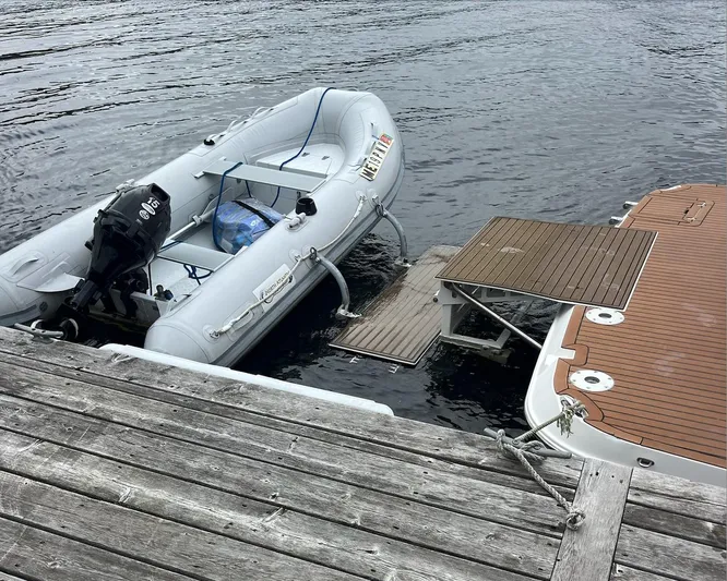  Yacht Photos Pics 2006 Rinker 390 Express Cruiser docked with inflatable boat on water.
