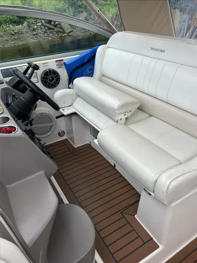  Yacht Photos Pics 2006 Rinker 390 Express Cruiser cockpit with white leather seating and wooden flooring.