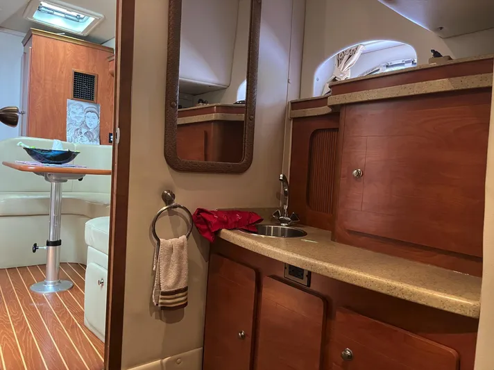  Yacht Photos Pics 2006 Rinker 390 Express Cruiser interior with kitchenette and seating area.