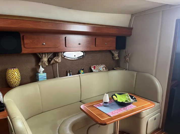  Yacht Photos Pics Interior of 2006 Rinker 390 Express Cruiser with beige seating and wooden table.