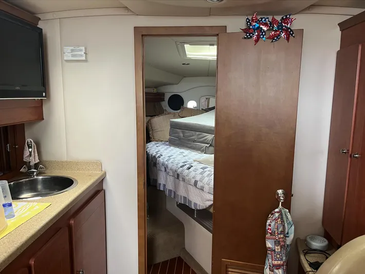  Yacht Photos Pics Interior of 2006 Rinker 390 Express Cruiser with kitchenette and cozy sleeping area.