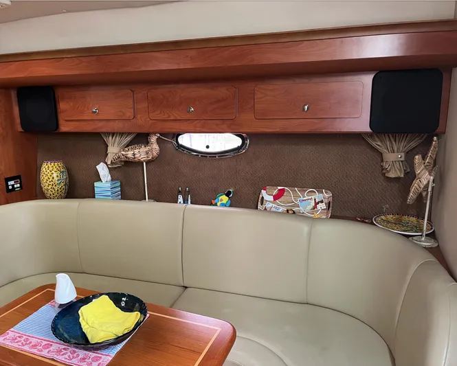  Yacht Photos Pics Interior of 2006 Rinker 390 Express Cruiser with beige seating and wooden cabinetry.